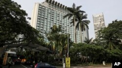FILE - In this June 2, 2018, file photo, police officers conduct security checks outside the Shangri-la hotel during the 17th International Institute for Strategic Studies (IISS) Shangri-la Dialogue, an annual defense and security forum in Asia, in Singap