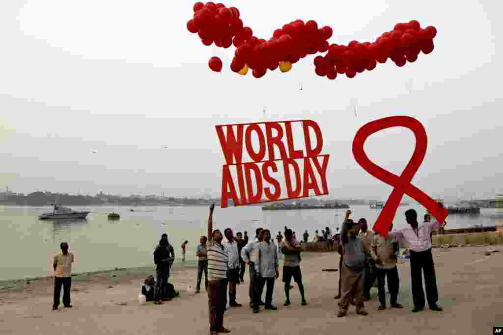 Activists prepare to release campaign materials into the air ahead of World AIDS Day on the banks of the Ganges River in Kolkata, India, Nov. 30, 2016.