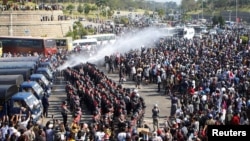 Police fire a water cannon at protesters demonstrating against the coup and demanding the release of elected leader Aung San Suu Kyi, in Naypyitaw, Myanmar, February 8, 2021. (REUTERS)