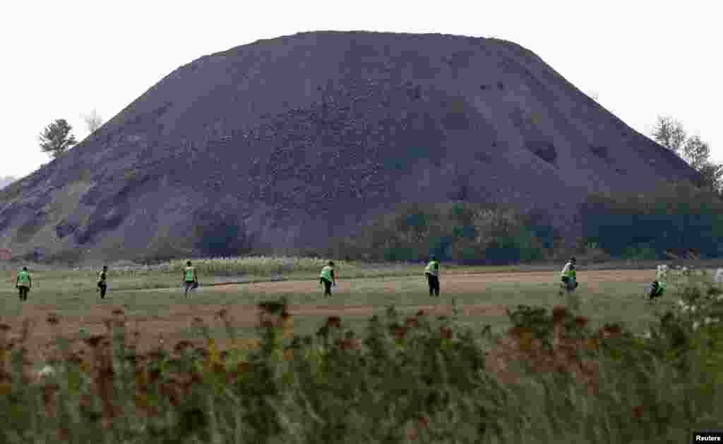 Dutch and Australian forensic experts continue recovery work near the village of Rozsypne, in the Donetsk region, Aug. 4, 2014.