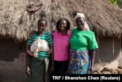 Evelyn Aloyo (L), Agnes Igoye (M) and Rose Apiyo pose for a portrait in front of a hut in Cornerward village, Paicho sub-county, Gulu district in Northern Uganda, March 26, 2018.