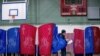 New Hampshire primary voters wait for their voting precinct to open outside Parker-Varney Elementary School, Tuesday, Feb. 11, 2020, in Manchester, N.H. 