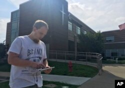 FILE - Jonathan Nickell checks his iPad while waiting for his wife to have surgery at the St. Joseph Mount Sterling hospital in Mount Sterling, Kentucky, July 14, 2017.