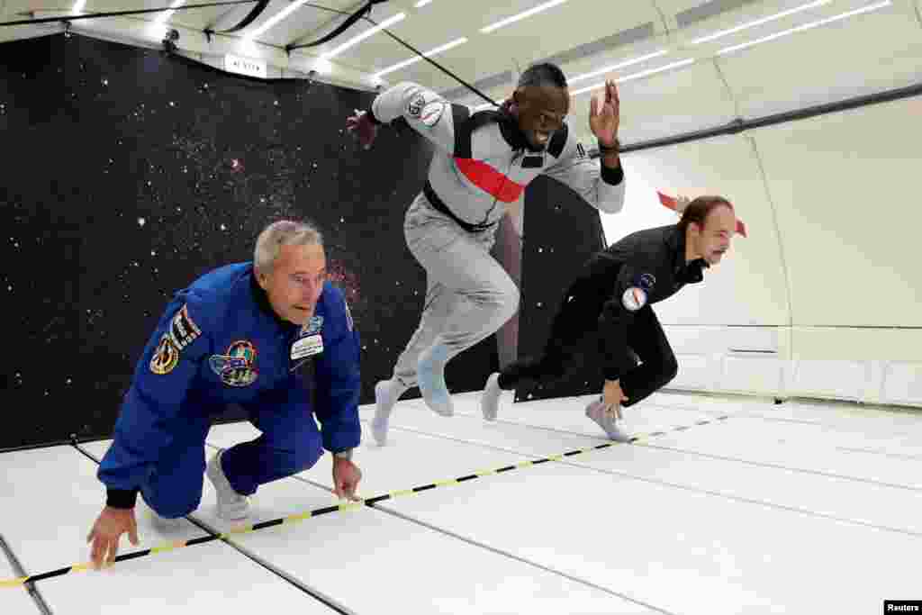 Retired sprinter Usain Bolt (center), French astronaut Jean-Francois Clervoy (left), CEO of Novespace, and French Interior designer Octave de Gaulle, who designed a bottle of "Mumm Grand Cordon Stellar," enjoy zero gravity conditions during a flight in a specially modified Airbus Zero-G plane above Reims, France.