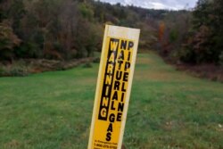 FILE - A post marks the location of a shale gas pipeline in Zelienople, Pa., Oct. 17, 2019.