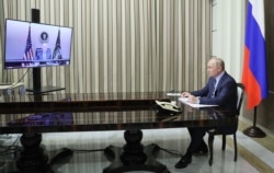 Russian President Vladimir Putin attends a meeting with US President Joe Biden via a video call in the Black Sea resort of Sochi on December 7, 2021. (Photo by Mikhail Metzel / SPUTNIK)