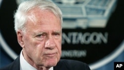 FILE - A 2004 photo shows former Defense Secretary James Schlesinger, chairman of the Detention Operations Review Panel speaking at the Pentagon.