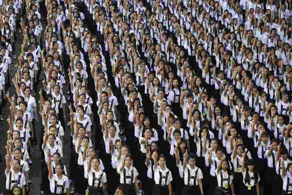 Students from St. Scholastica&#39;s College, an all-girls&#39; school, dance in a global kickoff campaign for One Billion Rising, Manila, Philippines, Feb. 14, 2013.