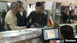 Afghan refugees submit documents at a refugee center in Tehran, Iran, Oct. 24, 2016. Many young men who left Afghanistan for Iran and Pakistan are returning.