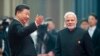 FILE - Chinese President Xi Jinping, left, welcomes Indian Prime Minister Narendra Modi for a meeting at a Shanghai Cooperation Organization summit in Qingdao in eastern China's Shandong province, June 10, 2018. 