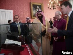 Britain's Archbishop of Canterbury Justin Welby shows The Crown Prince of Saudi Arabia Mohammed bin Salman the Birmingham Koran manuscript - one of the earliest surviving records of the Koran, written in Hijazi, and radiocarbon dated to between 568 and 645 AD - during a private meeting at Lambeth Palace, London, Britain, March 8, 2018.