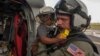 Naval Aircrewman 2nd Class Brandon Larnard, assigned to Helicopter Sea Combat Squadron, carries an evacuee off an MH-60S Sea Hawk helicopter following the landfall of Hurricane Maria on the island of Dominica, Sept. 27, 2017. 