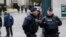 Policemen guard the entrance of the Pere Lachaise cemetery during the funeral of French cartoonist Georges Wolinski, in Paris, Thursday, Jan. 15, 2015. 
