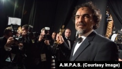 FILE - Alejandro G. Iñárritu backstage with the Oscar® for Original screenplay, for work on “Birdman or (The Unexpected Virtue of Ignorance)” during the live ABC Telecast of The 87th Oscars® at the Dolby® Theatre in Hollywood, California, Feb. 22, 2015.