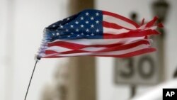 An American flag waves in wind from Hurricane Matthew in St. Augustine, Florida, Oct. 7, 2016.