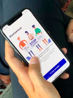 French Digital Affairs junior minister Cedric O demonstrates how to use the French app StopCovid in Paris, May 29, 2020. (AP Photo/Masha Macpherson)