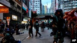 FILE - Riot police tell journalists to leave while they arrest protesters in Hong Kong, Oct. 6, 2019. 