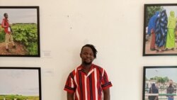 Nigerian photojournalist Damilola Onafuwa poses with some photos he took from conflict areas for the Center for Civilians in Conflict, in Abuja, September 21, 2021. (Timothy Obiezu/VOA)