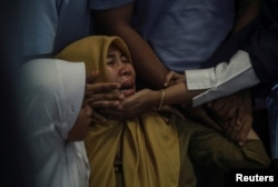 Relatives of passengers of Lion Air, flight JT610, that crashed into the sea cry at Depati Amir Airport in Pangkal Pinang, Belitung island, Indonesia, October 29, 2018.