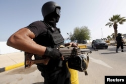 A member of the force assigned to protect Libya's unity government stands at the entrance to where the government has their offices, in Tripoli, Libya, April 14, 2016.