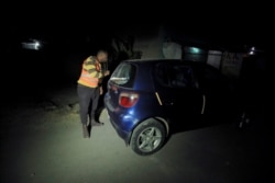 An unarmed vigilante searches a vehicle at a neighborhood in Bole, following Ethiopian Prime Minister Abiy Ahmed's call for citizens to protect their areas from Tigray People's Liberation Front (TPLF), in Addis Ababa, Nov.19, 2021.