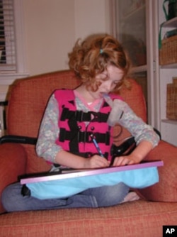 Ava Downs’ twice-a-day therapy involves a vest that vibrates her chest to shake sticky mucus from her lungs.