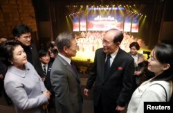 South Korean President Moon Jae-in talks with president of the Presidium of the Supreme People's Assembly of North Korea Kim Young Nam as Kim Yo Jong, the sister of North Korea's leader Kim Jong Un, looks on.