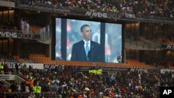 President Barrack Obama speaks to mourners attending the memorial service for former South African president Nelson Mandela at the FNB Stadium in Soweto near Johannesburg, Dec. 10, 2013.