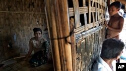 FILE - 17-year old Rorbiza rests at home of Dapaing, North of Sittwe, western Rakhine state, Myanmar after escaping from a human trafficking boat.
