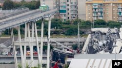 Cars are blocked on the Morandi highway bridge after a section of it collapsed, in Genoa, northern Italy, Aug. 14, 2018. 