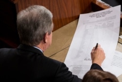 FILE - Sen. Roy Blunt, R-Missouri, signs an official tally to count Electoral College votes, certifying Donald Trump's presidential victory, Jan. 6, 2017.