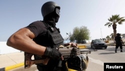 A member of the force assigned to protect Libya's unity government stands at the entrance to where the government has its offices, in Tripoli, Libya, April 14, 2016.