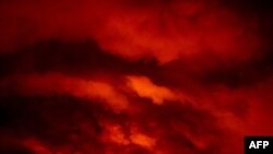 Fire from the Bootleg Fire illuminates smoke at night near Bly, Oregon, on July 16, 2021.