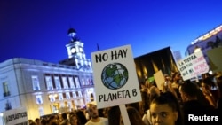 A woman holds a placard reading "There is no Planet B" during a protest demanding global politicians urgent actions to fight climate change in Madrid, Spain, September 27, 2019. REUTERS/Juan Medina