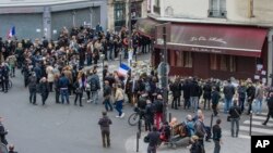 The moon rises in its waxing gibbous stage behind a statue atop the Erie County Court Building, in Buffalo, New York, Dec. 2, 2017.