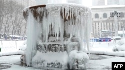 This photo is of a frozen fountain in New York City's Bryant Park during a winter storm on February 1, 2021. (Photo by TIMOTHY A. CLARY / AFP)