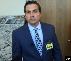 FILE - Greg Orman, independent candidate for Kansas governor, answers questions from reporters Aug. 23, 2018, in Topeka, Kan.