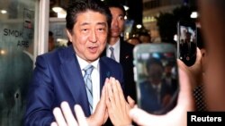 Japan's Prime Minister Shinzo Abe, leader of the Liberal Democratic Party, greets his supporters after making a speech at an election campaign rally in Tokyo, Japan, Oct. 20, 2017. 