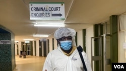 Journalist Hopewell Chin'ono arrives at the Harare Magistrate’s Court on Jan. 9, 2021, in full personal protective equipment, complaining about his continued 'persecution.' (Columbus Mavhunga/VOA) 