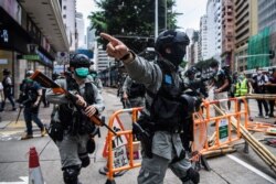 Riot police clear up debris left by protesters attending a pro-democracy rally against a proposed new security law in Hong Kong, May 24, 2020.