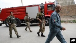 Security personnel arrive at the site of a rocket attack in Kabul, Afghanistan, July 20, 2021.