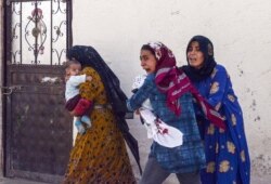 People run to take cover after mortars were fired from Syria, in Akcakale, Turkey, Oct. 10, 2019.