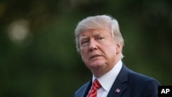 President Donald Trump walks from Marine One across the South Lawn of the White House in Washington, Wednesday, Aug. 23, 2017, as he returns from Reno, Nev.