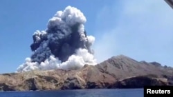 Smoke from the volcanic eruption of Whakaari, also known as White Island, is pictured from a boat, New Zealand December 9, 2019 in this picture grab obtained from a social media video. INSTAGRAM @ALLESSANDROKAUFFMANN/via REUTERS