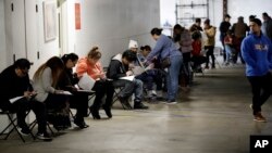 រូបឯកសារ៖ បុគ្គលិក​ផ្នែក​បដិសណ្ឋារកិច្ច​ដែល​បាន​បាត់បង់​ការងារ បំពេញ​ពាក្យ​សុំ​ជំនួយ​អត់ការងារ​ពី​រដ្ឋ កាលពី​ថ្ងៃសុក្រ ទី១៣ ខែមីនា ឆ្នាំ២០២០ នៅ​ទីក្រុង Los Angeles រដ្ឋ California។