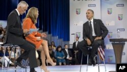 President Barack Obama participates in a town hall hosted by Univision and Univision news anchors Jorge Ramos (L) and Maria Elena Salinas (C), at the University of Miami, Florida, September 20, 2012.