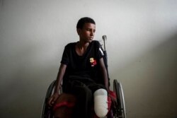 Mikiele Kahsay, 16, sits in a wheelchair at the Ayder Referral Hospital in Mekele, in the Tigray region of northern Ethiopia, May 6, 2021. The teenager was wounded when a shell landed near him as he was kicking a ball at a school field in Bizet.