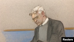 Julian Assange wearing two pair of glasses in seen in court during a hearing to decide whether he should be extradited to the United States, in London, Feb. 24, 2020 in this courtroom sketch.