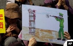 FILE - A drawing depicts a public execution of a North Korean soldier during a human rights rally in Seoul, South Korea, April 14, 2011.