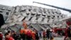 Rescue workers search a collapsed building from an early morning earthquake in Tainan, Taiwan, Feb. 6, 2016. 